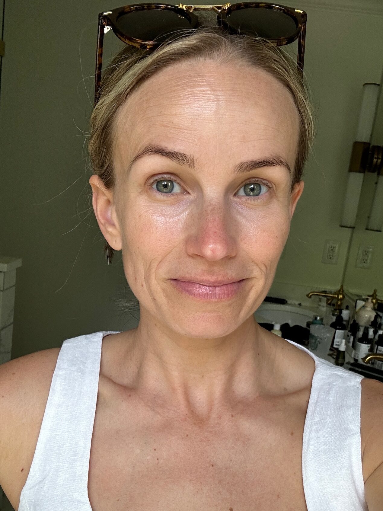 Woman showing close up of face before using vitamin C serum