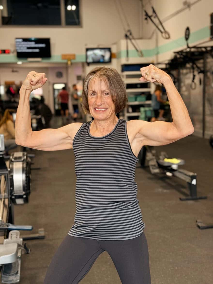 Woman flexing muscles while at the gym
