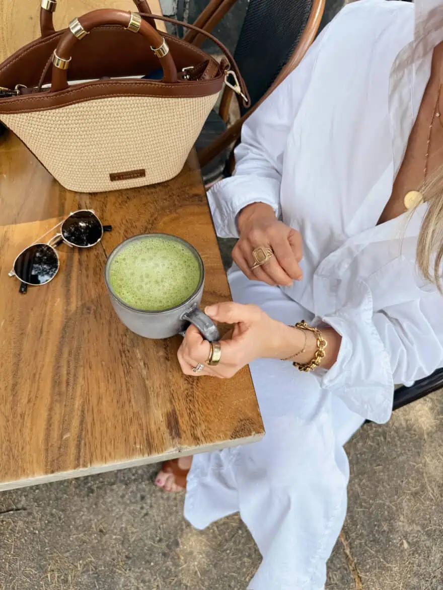 Woman drinking matcha in white outfit