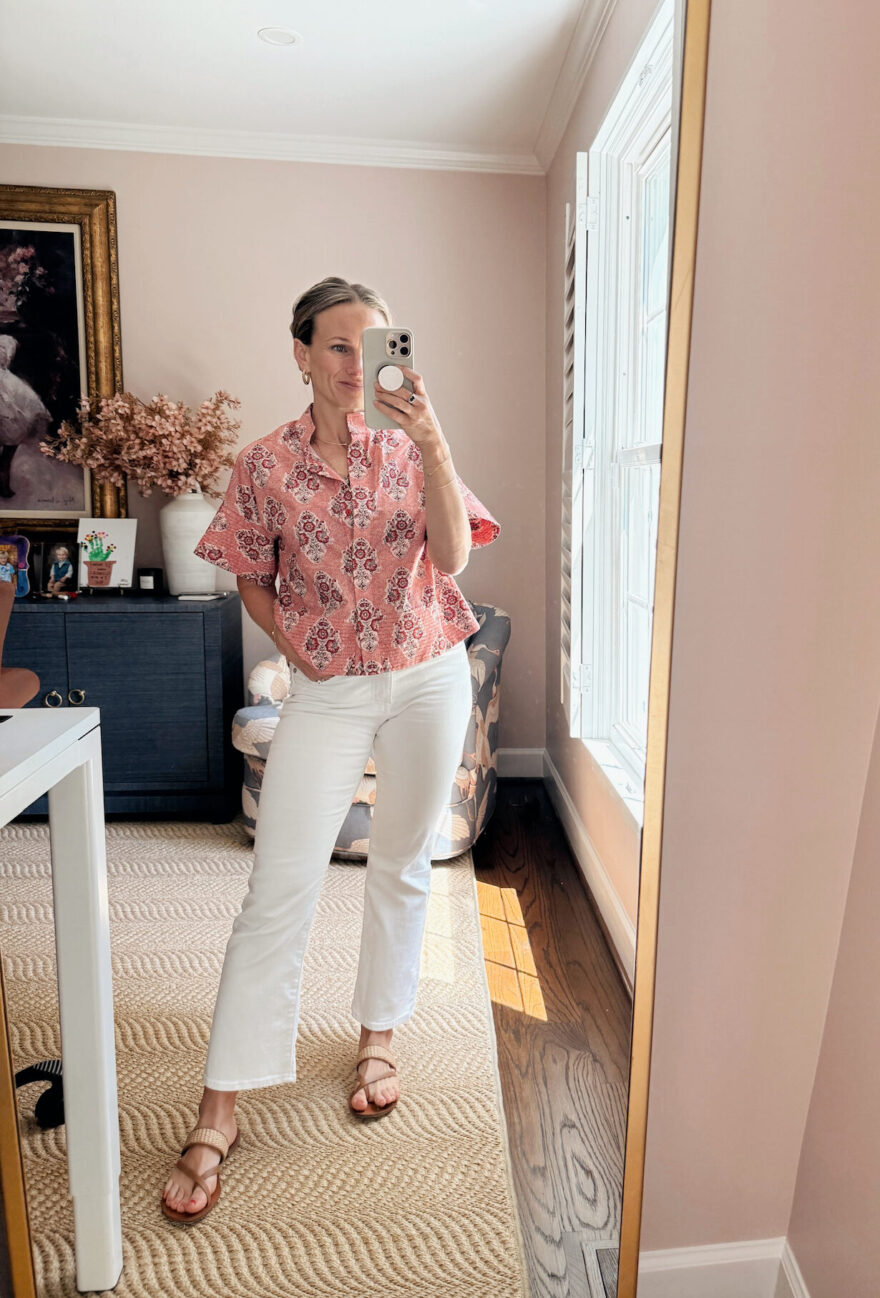 Woman wearing pink blouse with white pants from Tuckernuck