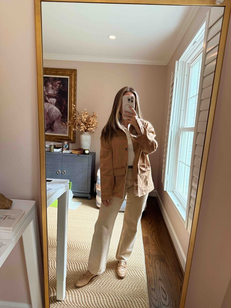 TeriLyn Adams wearing a rust barn jacket, white polo, and tan pants with loafers