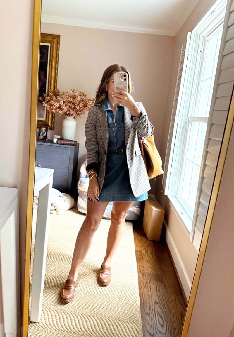 TeriLyn Adams wearing a denim dress, plaid blazer, and brown loafers with a tan tote