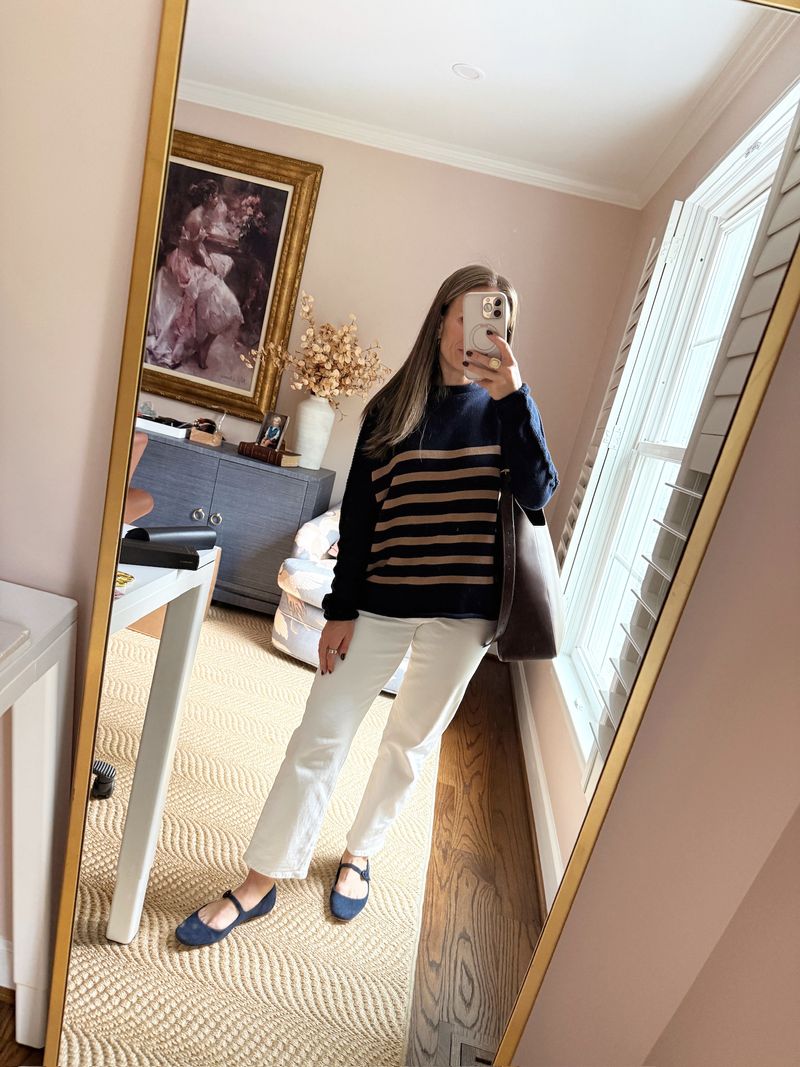 TeriLyn Adams wearing a navy striped sweater, white jeans, and navy Mary Jane flats