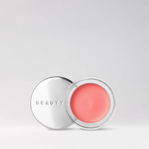 Beauty Pie Supercheek cream blush in a coral-pink shade, shown in an open compact
