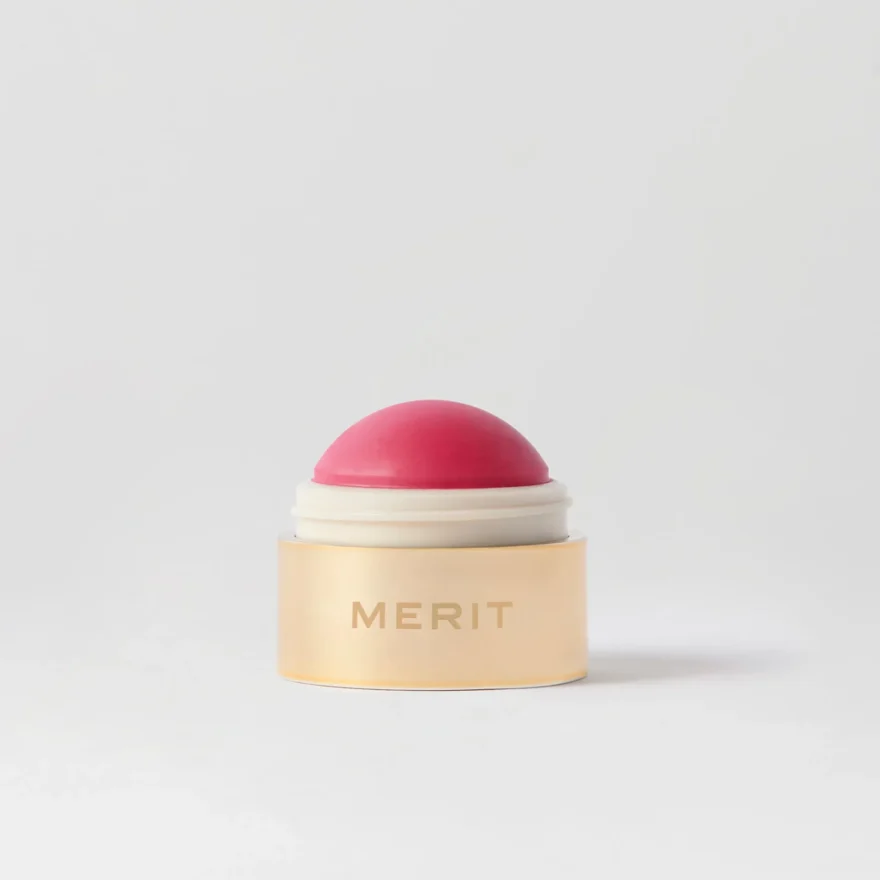 MERIT Flush Balm cream blush, a bright pink dome-shaped stick