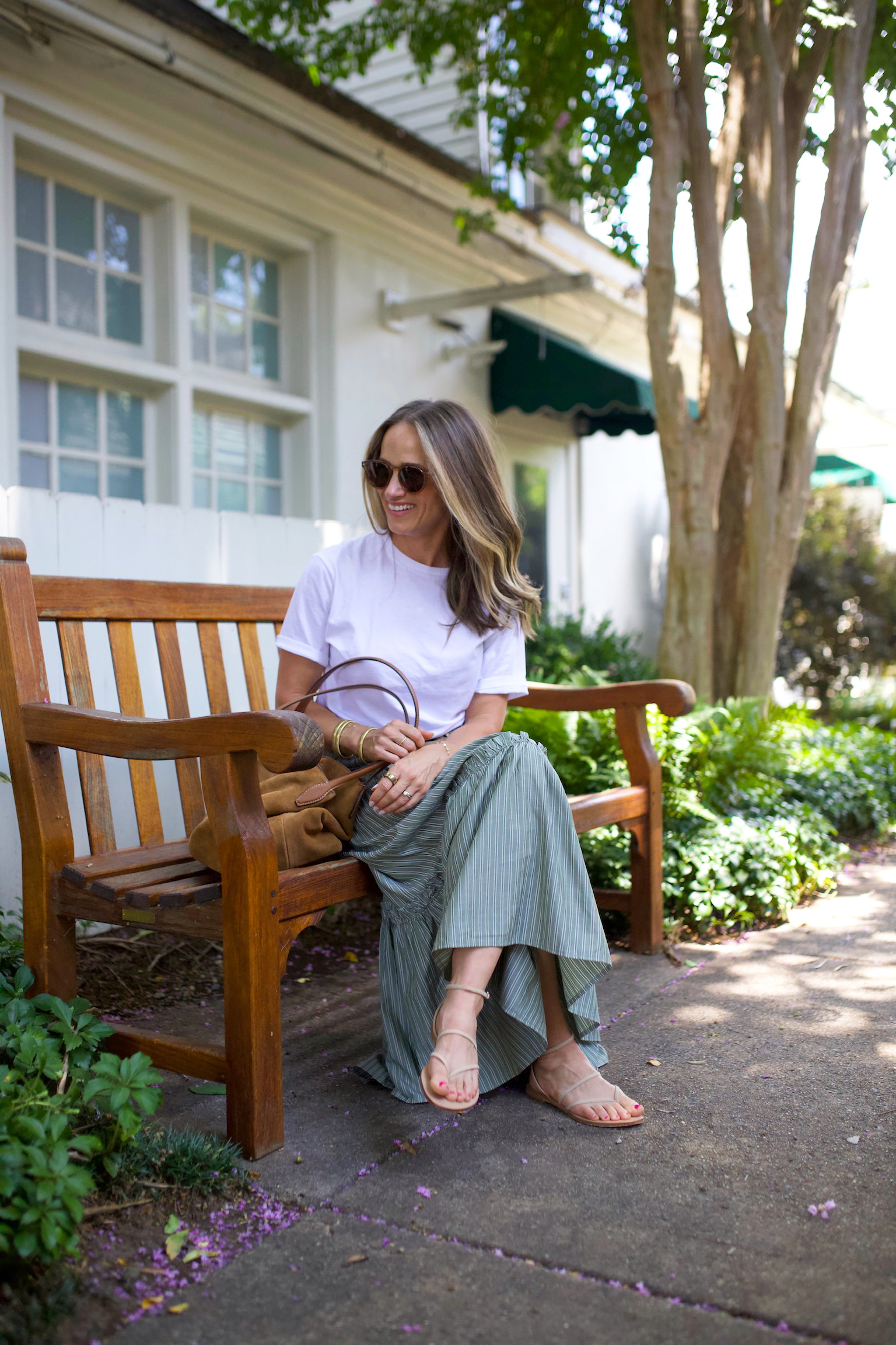 TeriLyn Adams wearing a white t-shirt tucked into a green striped maxi skirt with a leather belt