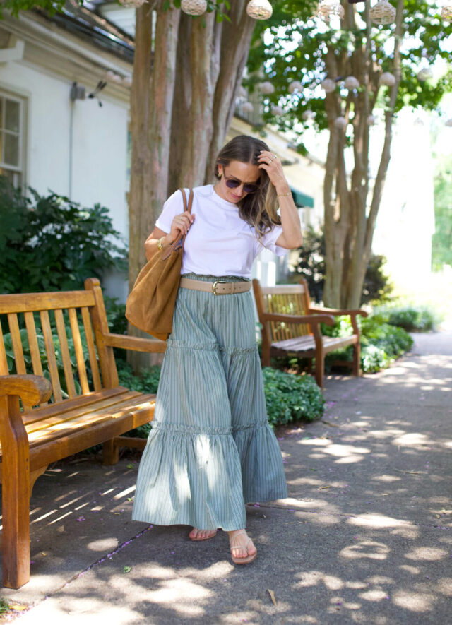 Woman wearing maxi skirt with belt and white shirt