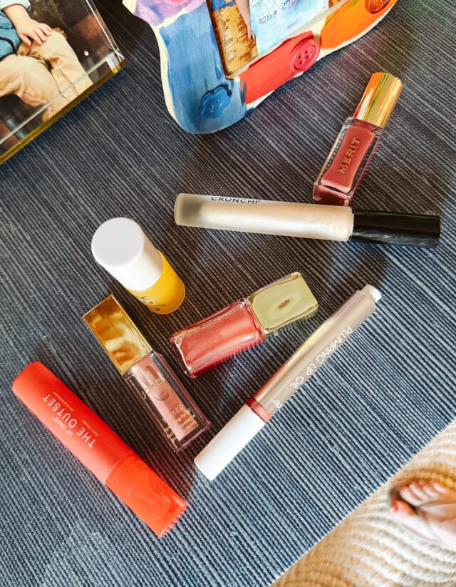 Lip glosses laid out on table