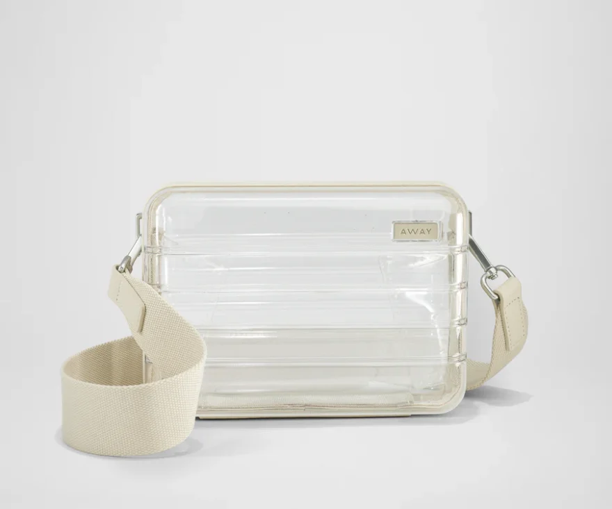 Away hard-sided clear bag with structured shape and canvas strap