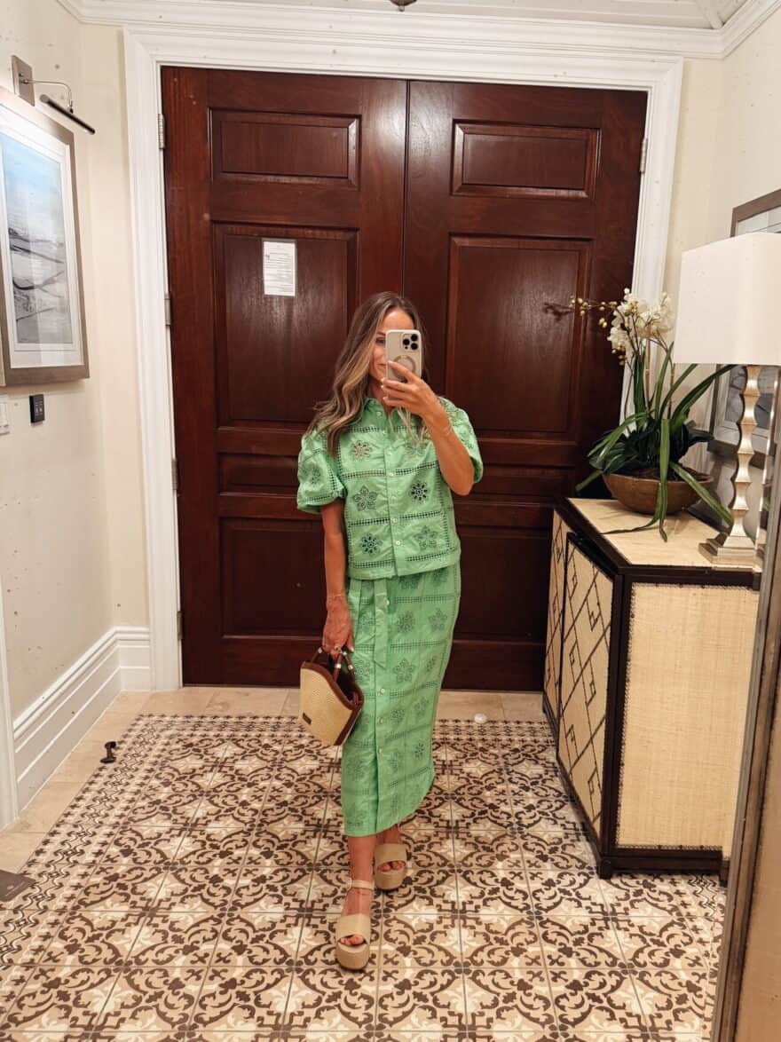 TeriLyn Adams wearing green top and skirt set with platform raffia heels