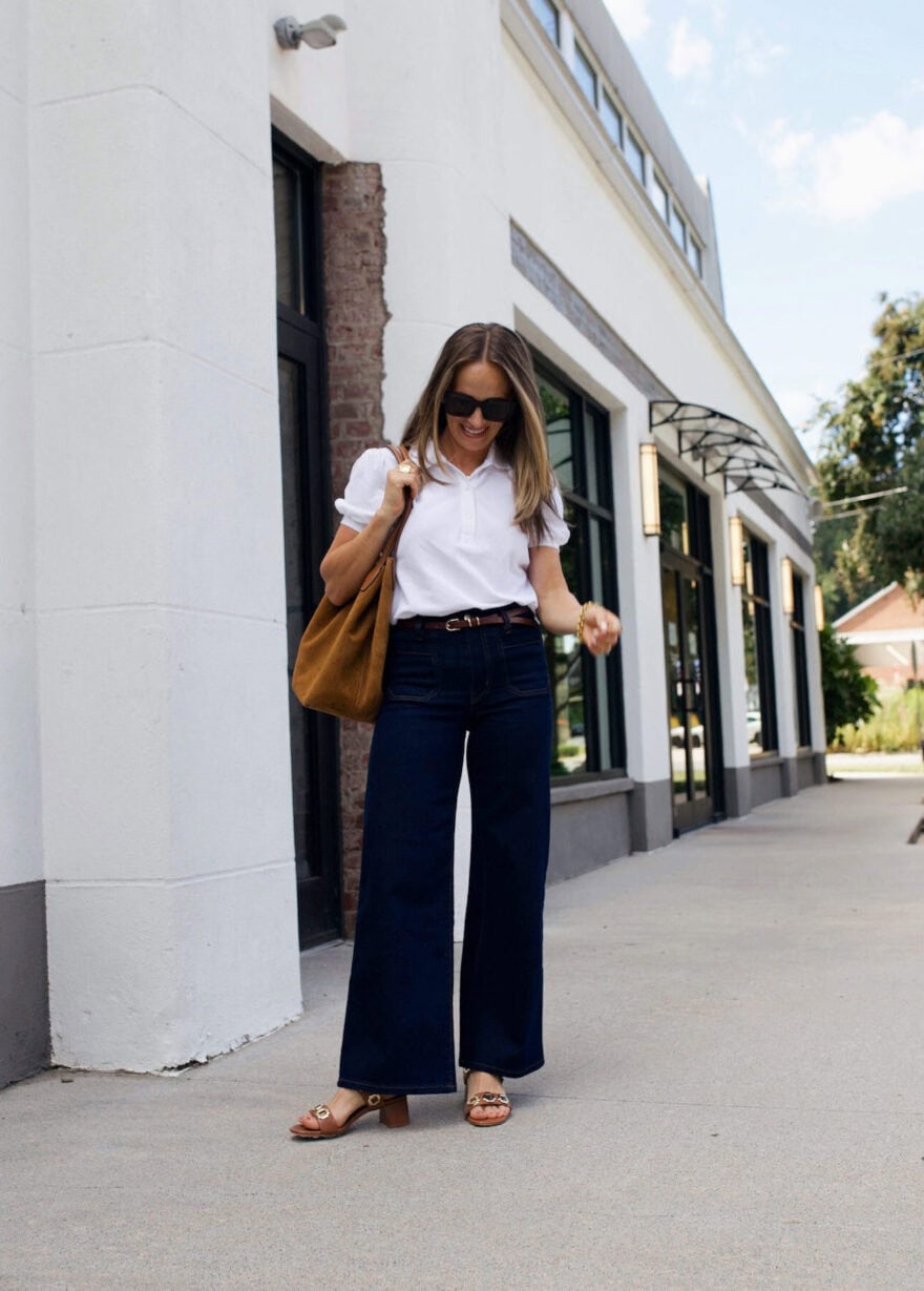 Woman wearing wide leg jeans and a white top