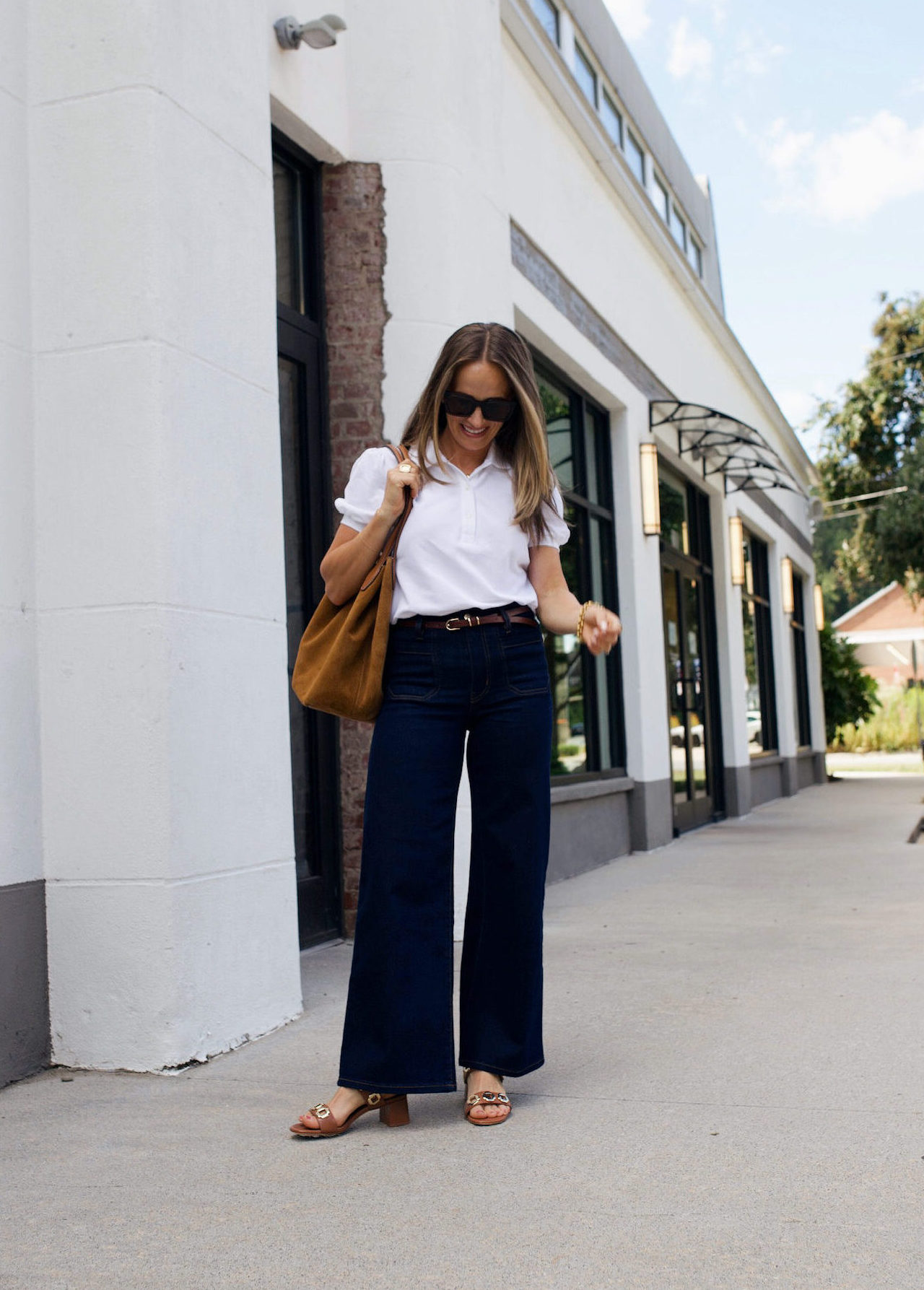 Woman wearing wide leg jeans and a white top