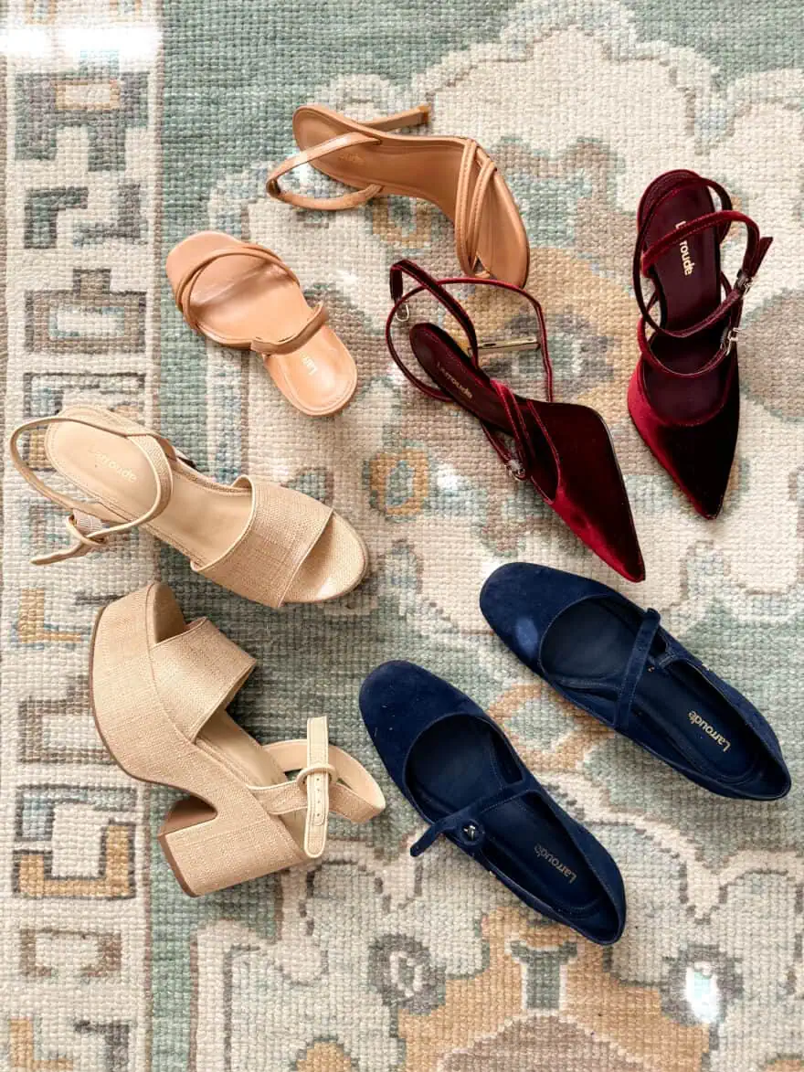 Pairs of Larroude shoes arranged on a rug