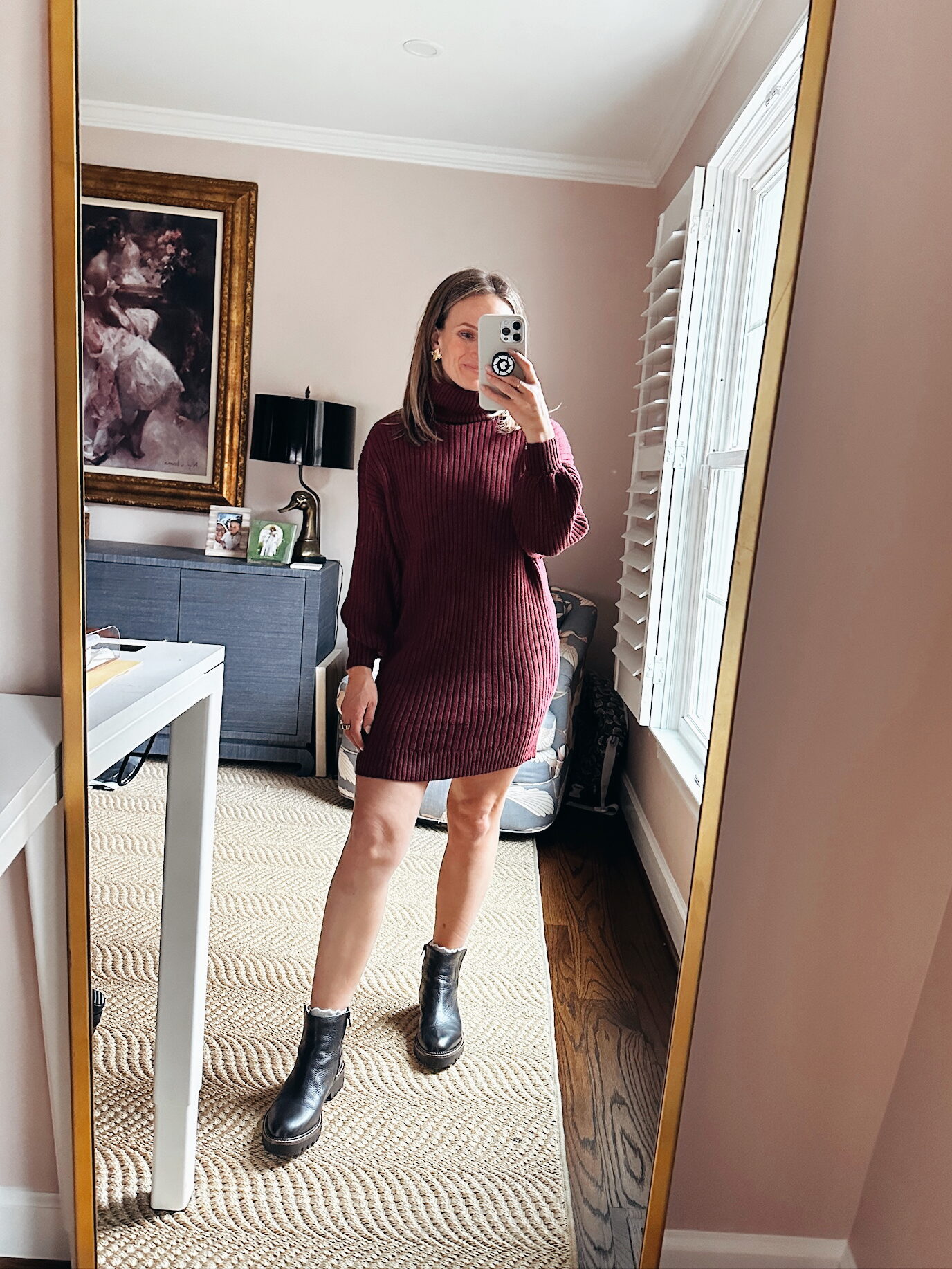 Woman wearing Chelsea Boots with a sweater dress
