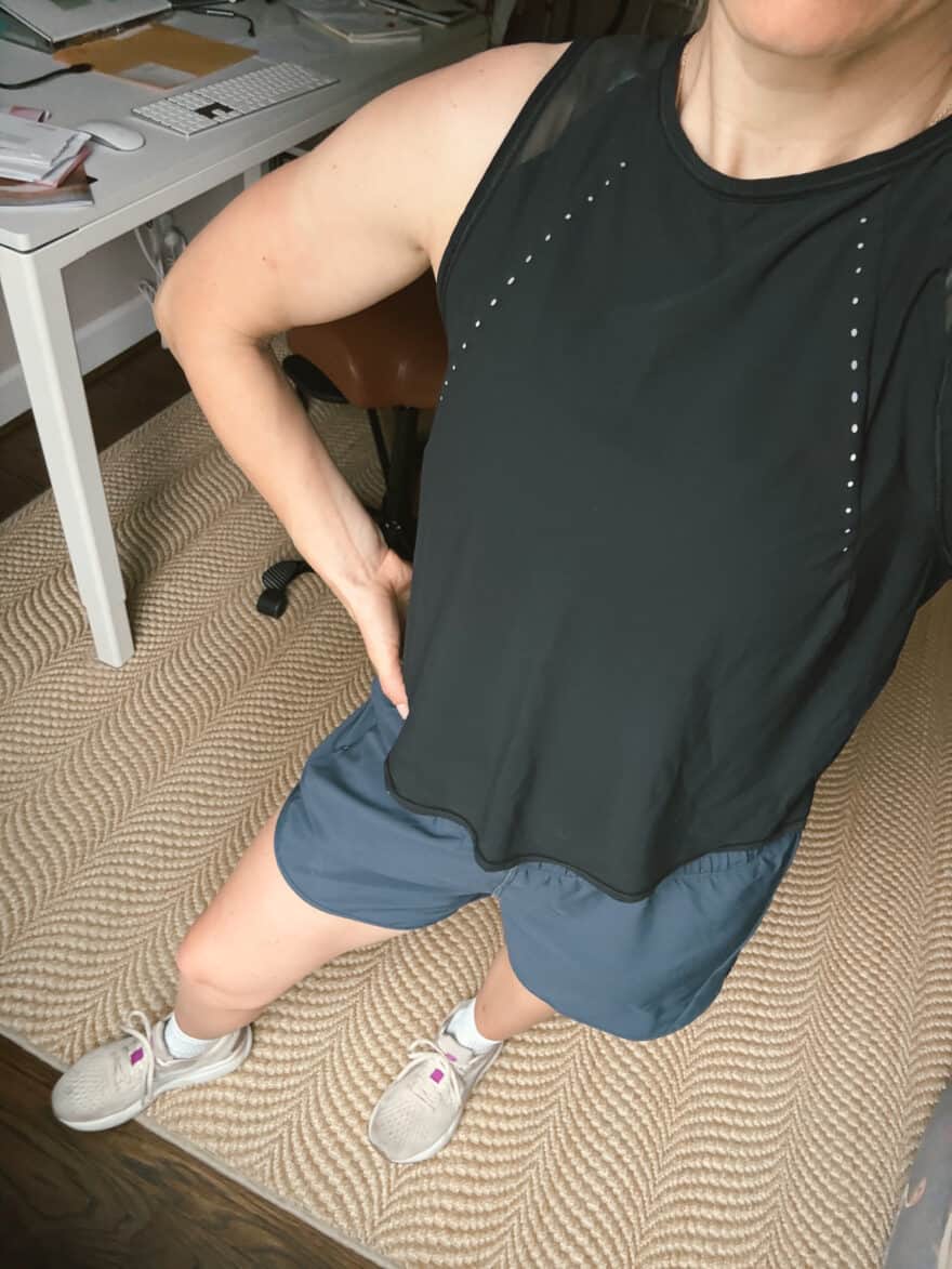woman about to workout in black tank and amazon workout shorts