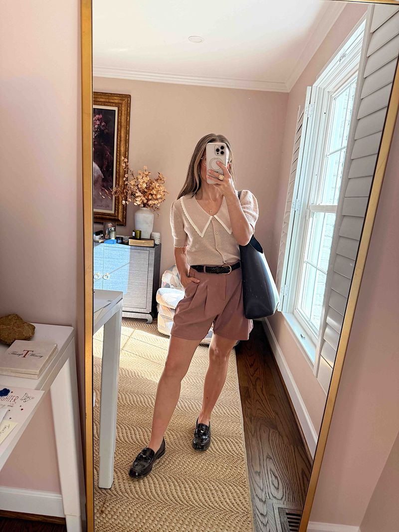 TeriLyn Adams wearing a collared sweater, mauve trouser shorts, and Grayson Penny Loafers