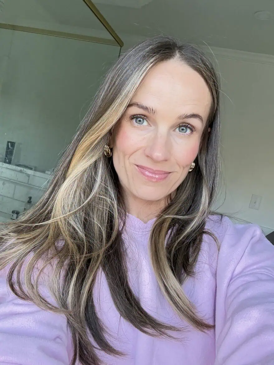 Woman showing her face after using HT Skin Glow Setting Spray