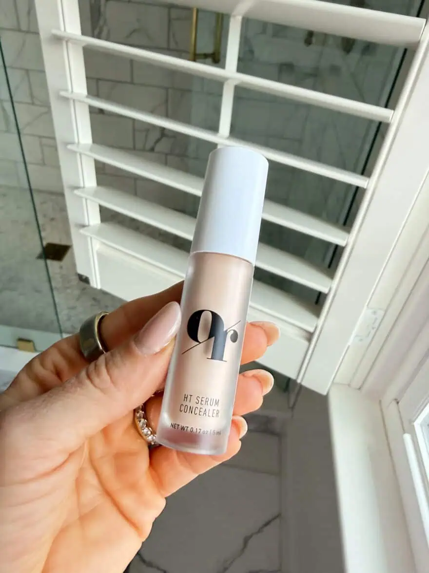 Woman holding Olive Rose serum concealer