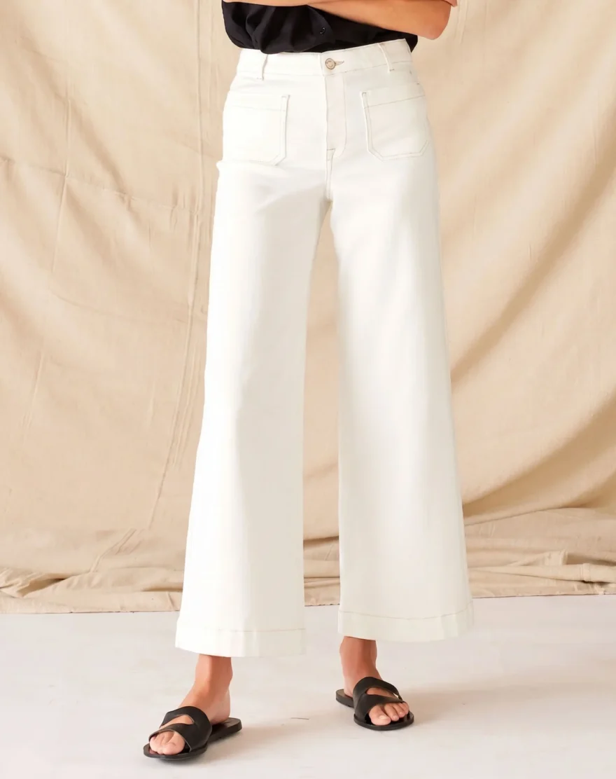 Mersea Cropped White Wide Leg Jeans worn by a model with a black top
