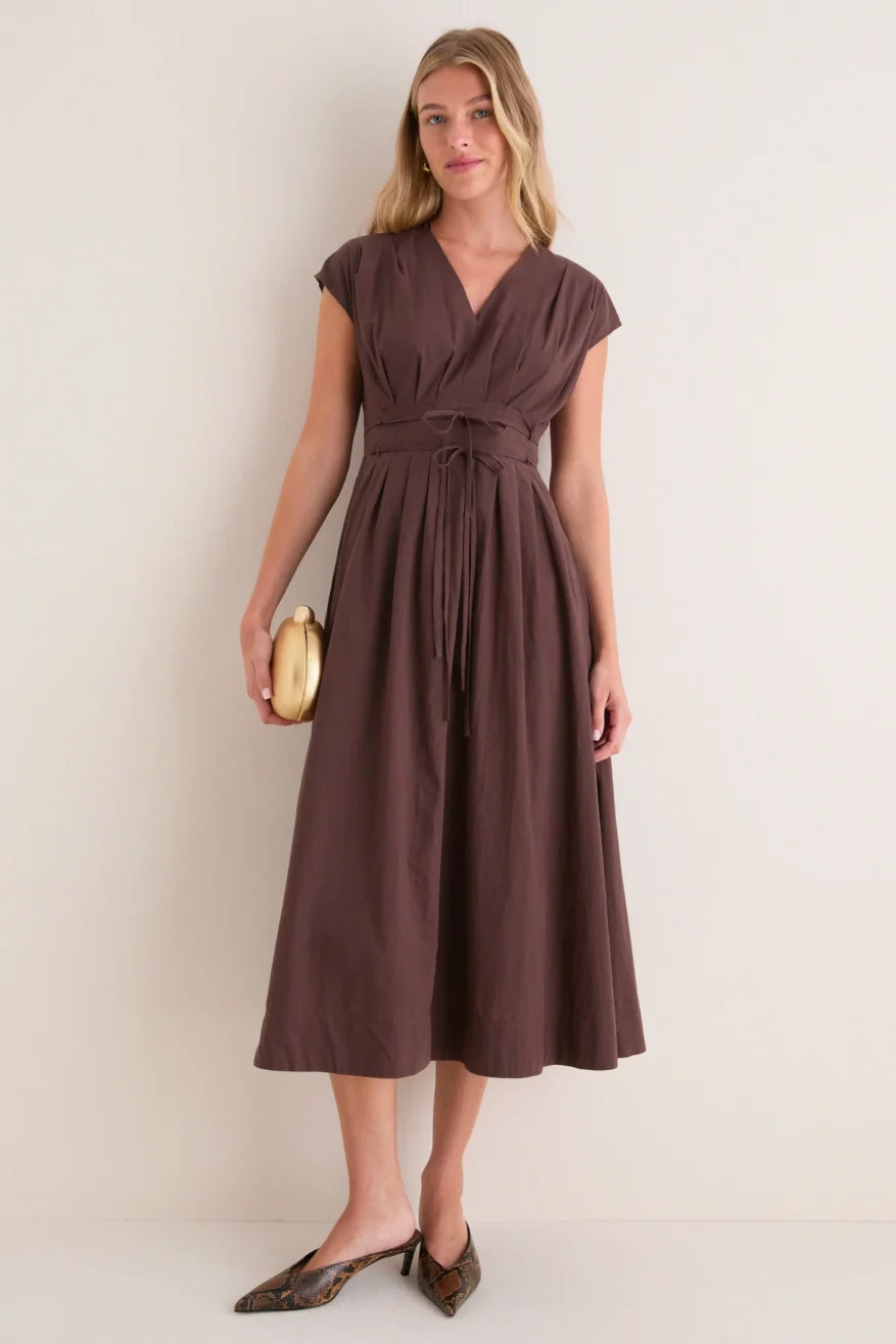 Tuckernuck Pleated V-Neck Midi Dress in brown worn by a model