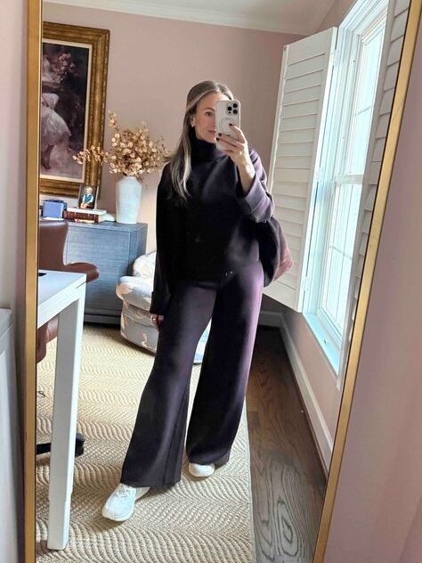 Woman taking a selfie while wearing a SPANX lounge set