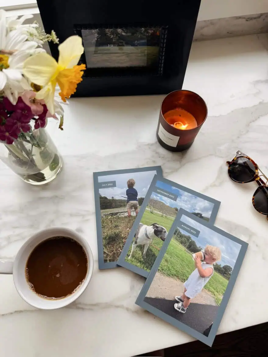 Chatbooks sitting on counter with coffee and a candle