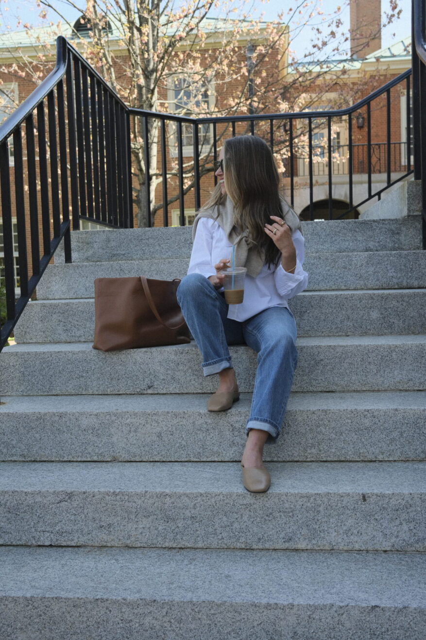 TeriLyn Adams wearing an oversized white button-down with cuffed jeans and a sweater tied over her shoulders
