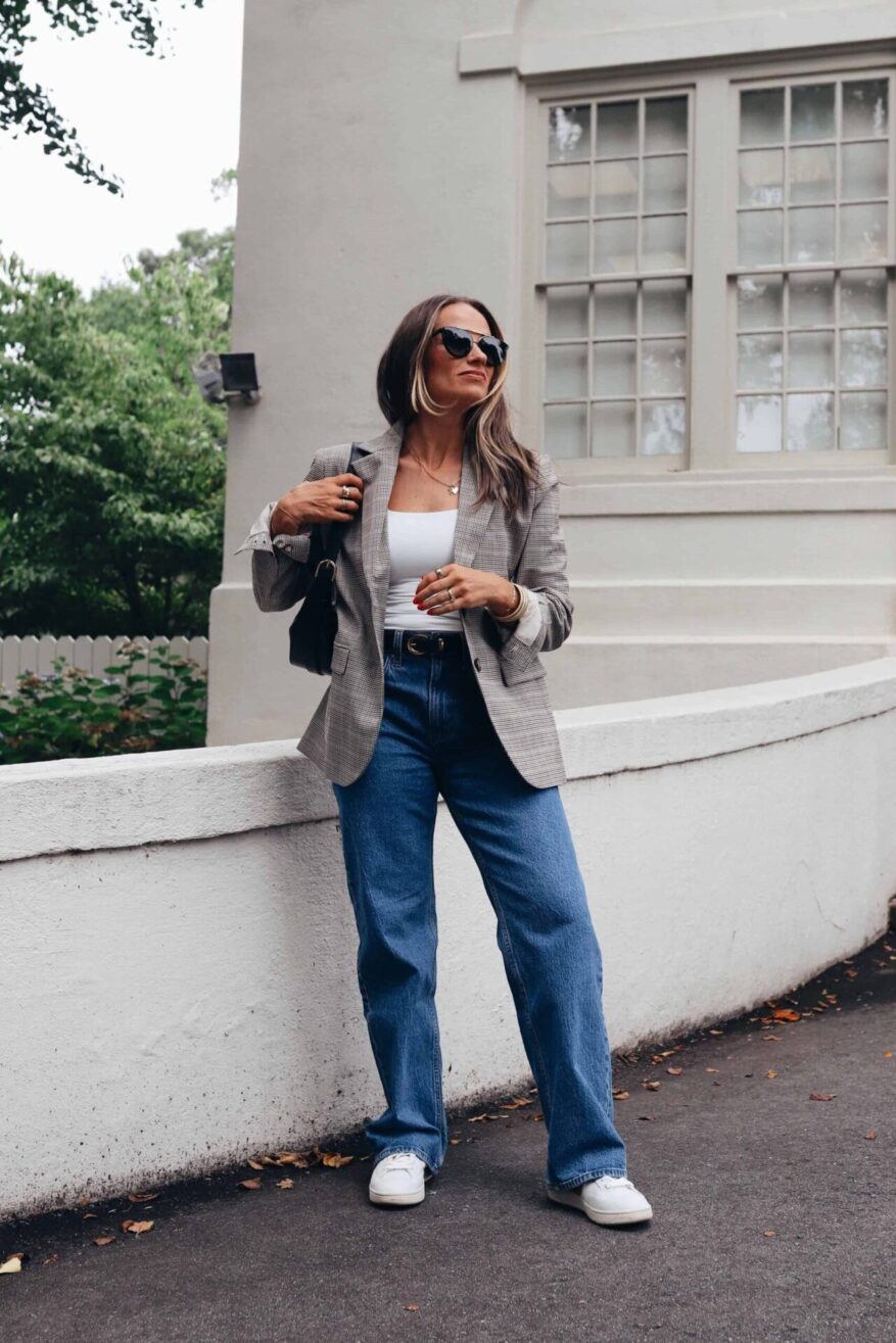 TeriLyn Adams wearing a plaid blazer over a white tank and wide-leg jeans with white sneakers