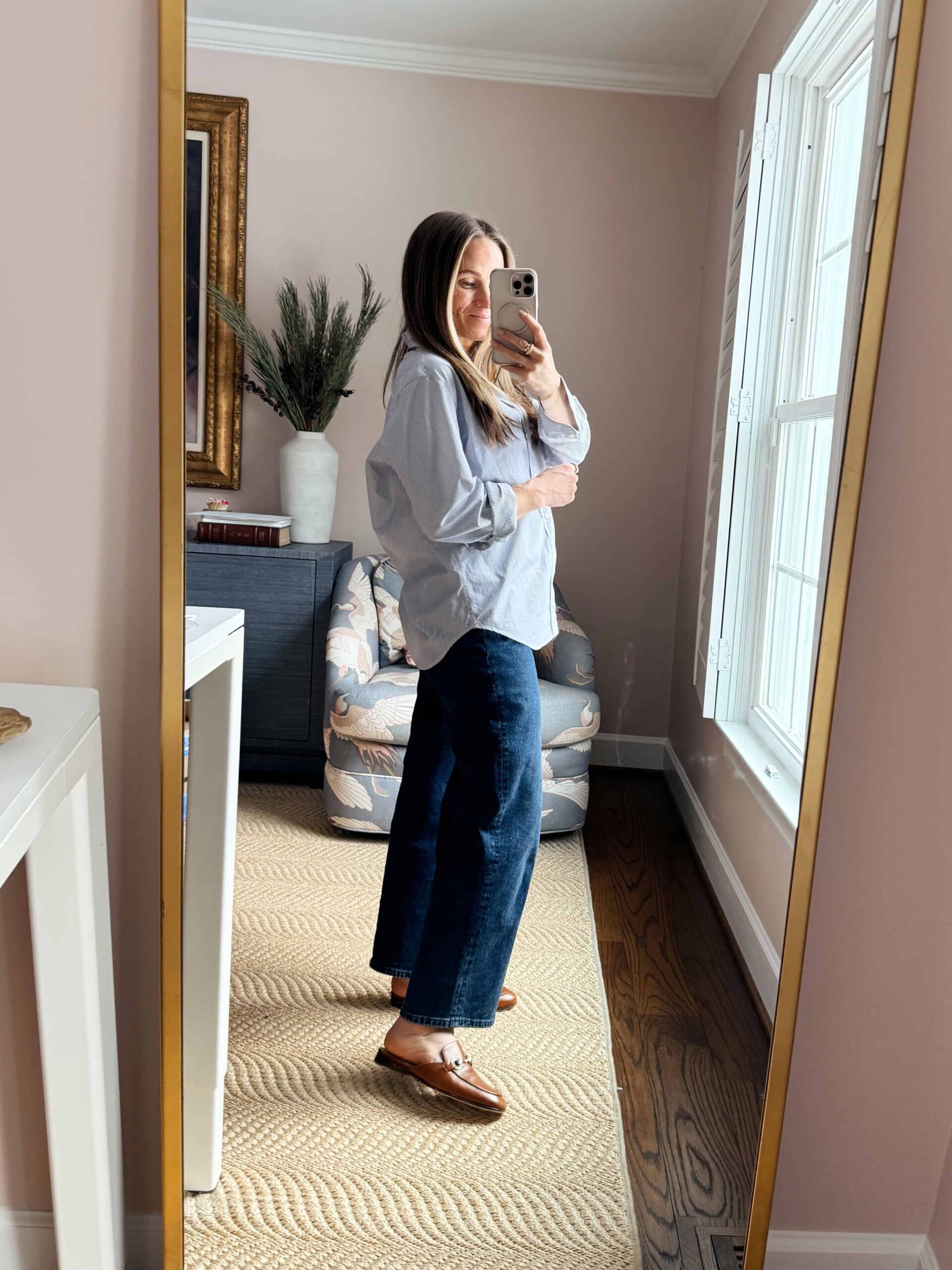 Woman wearing wide-leg jeans with a button up top