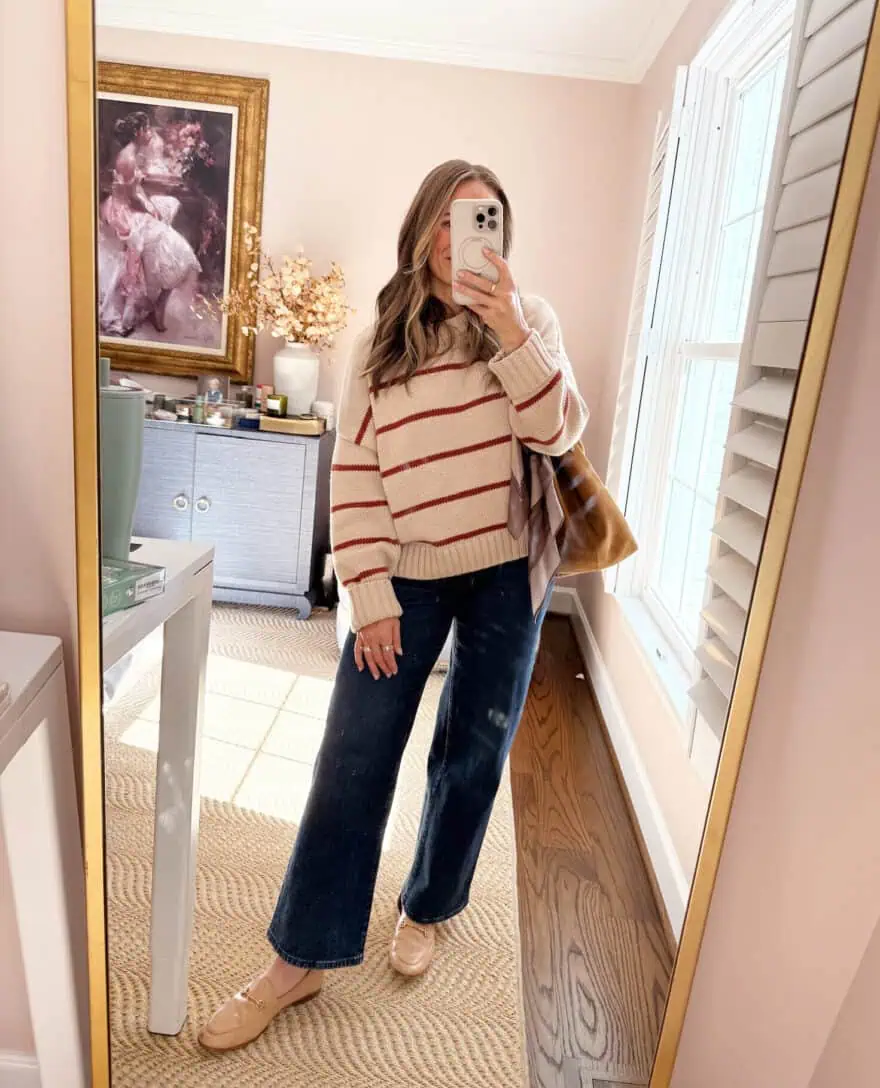 Woman wearing jeans and striped sweater with loafers