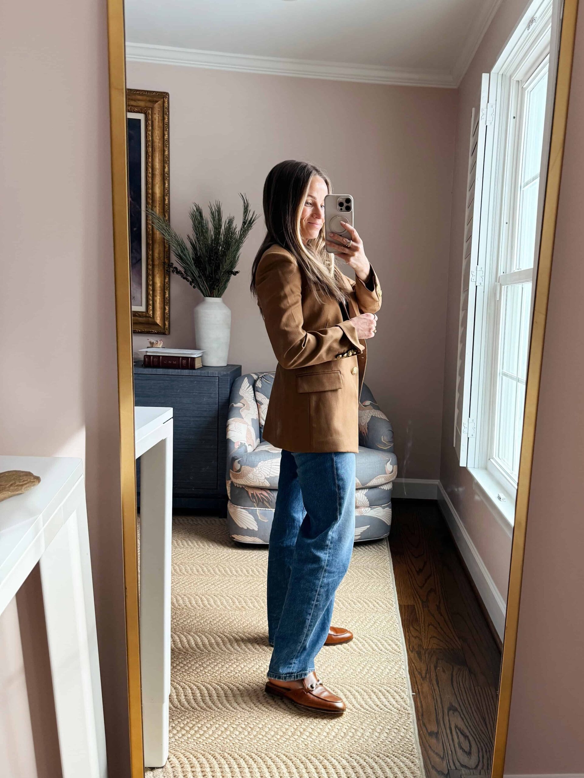 Woman wearing wide-leg jeans with tailored blazer and loafers