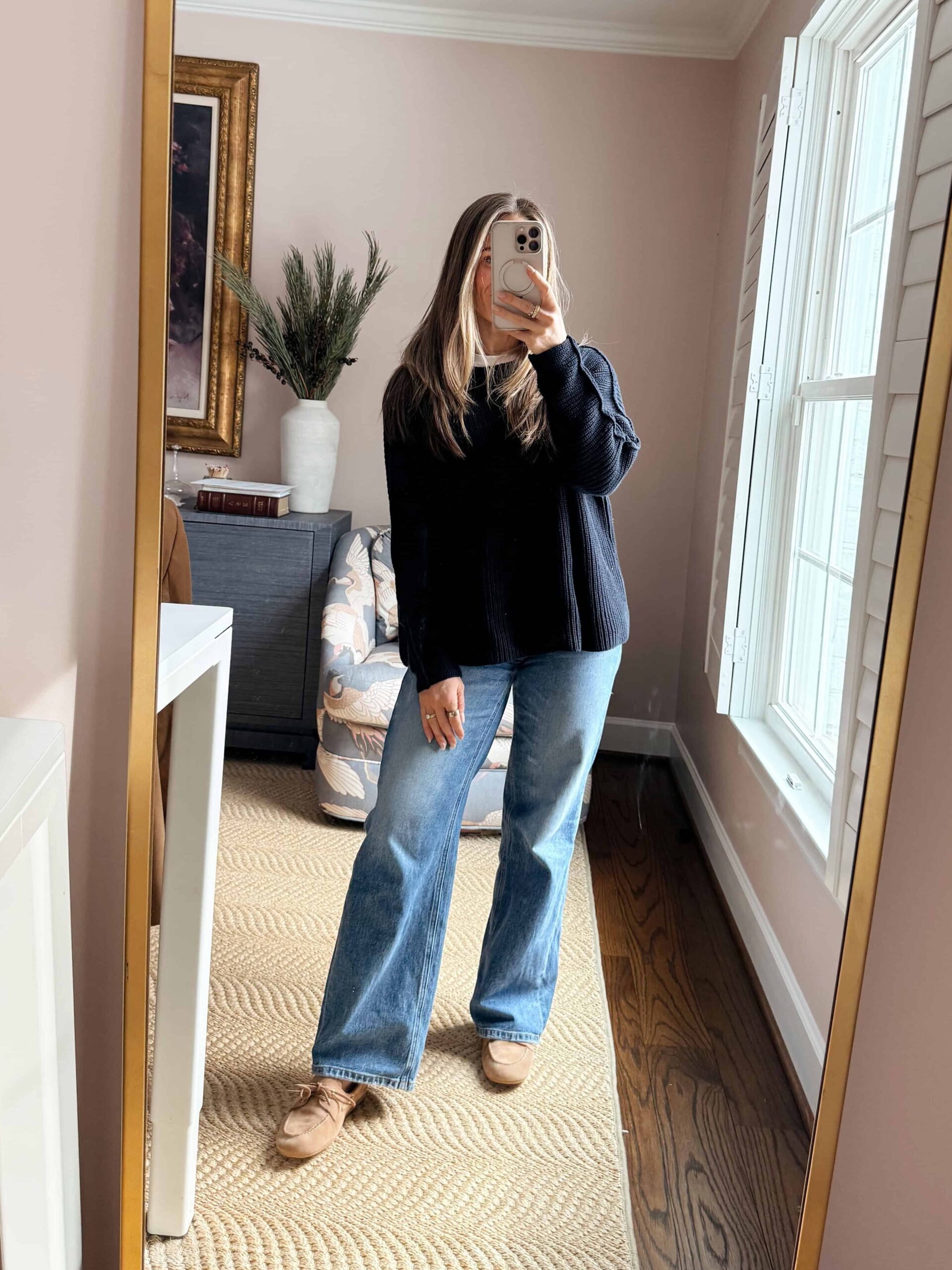 Woman wearing wide-leg jeans with oversized sweater