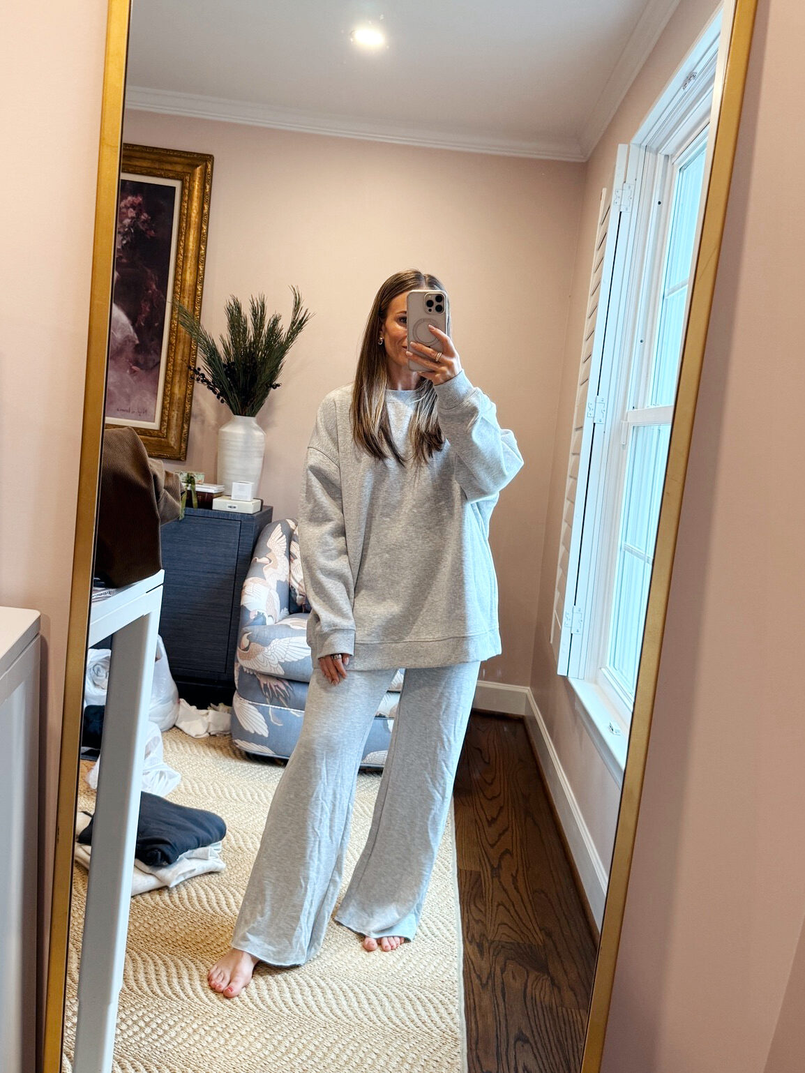 Woman wearing gray sweatpants and pullover