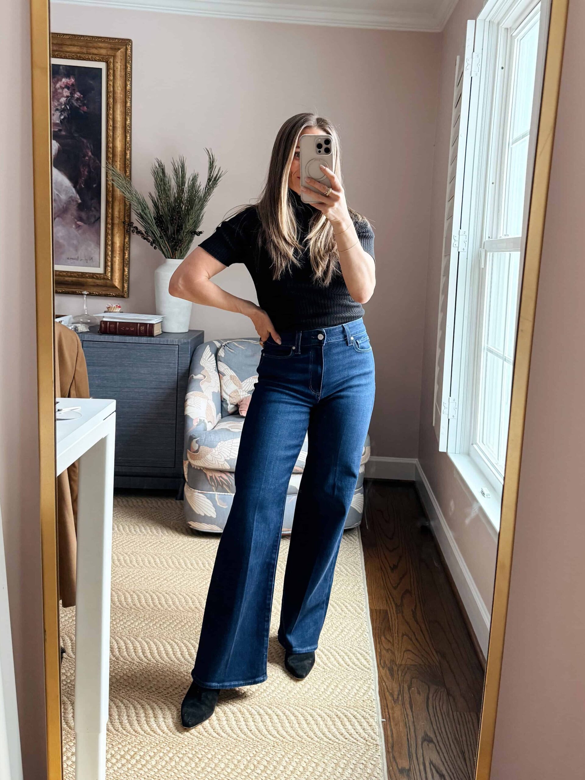 Woman wearing wide-leg jeans with a fitted top and pointy-toed heels