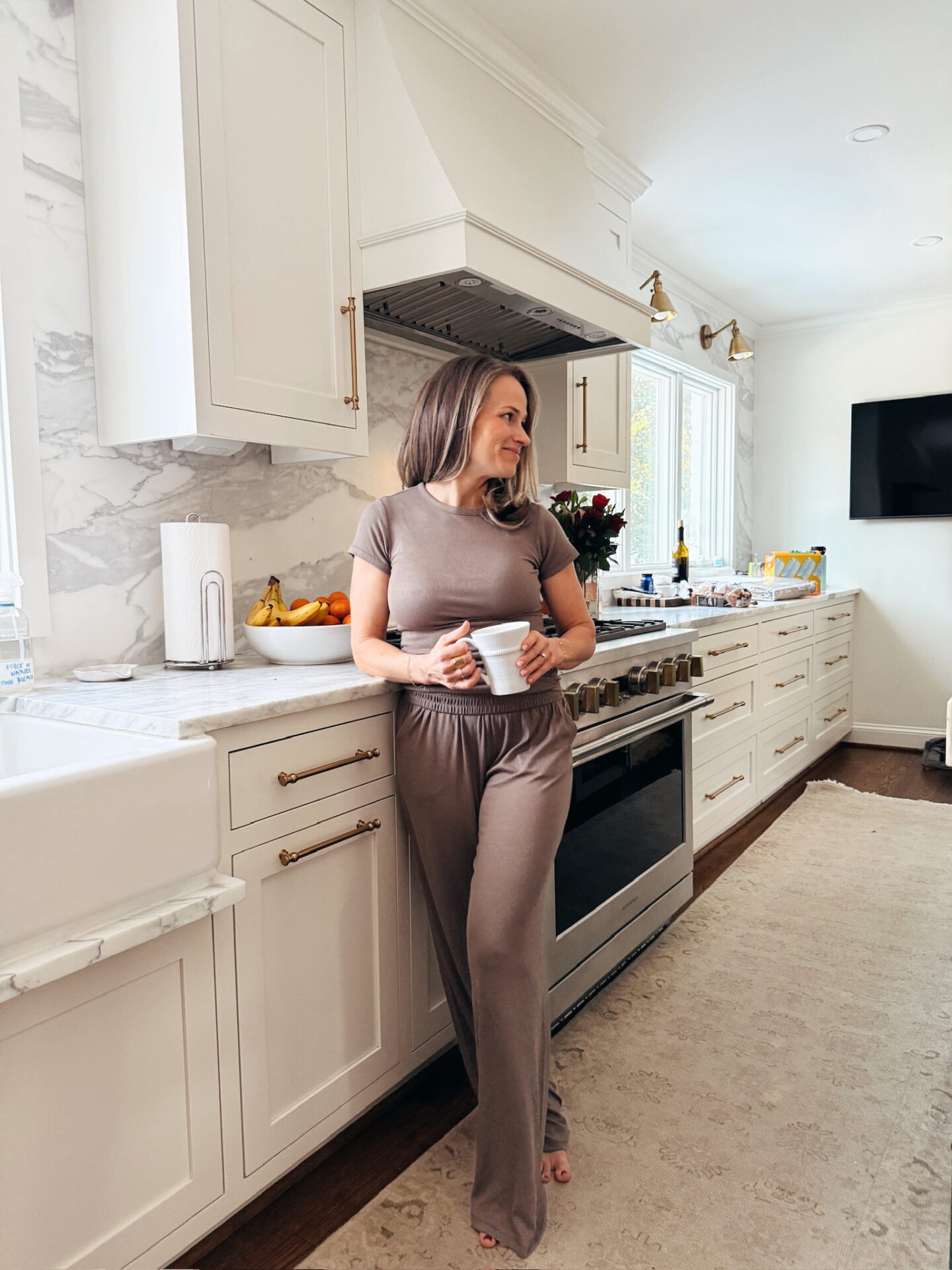 TeriLyn Adams wearing the Nuuds Slinky Rib tee and wide leg pants in her kitchen
