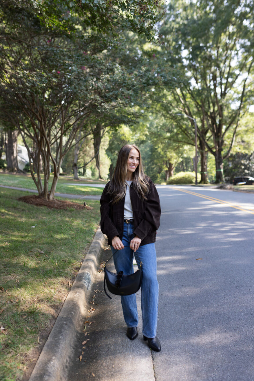 TeriLyn Adams wearing Abercrombie High Rise Wide-Leg Jeans with black ankle boots and a brown bomber jacket
