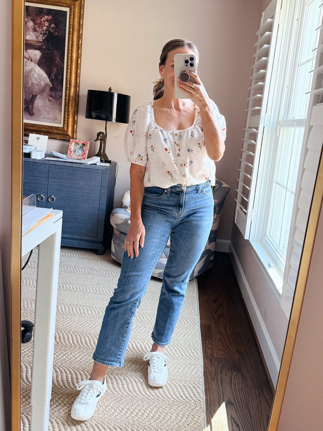 Woman wearing Tuckernuck shoes with denim and white blouse with flowers