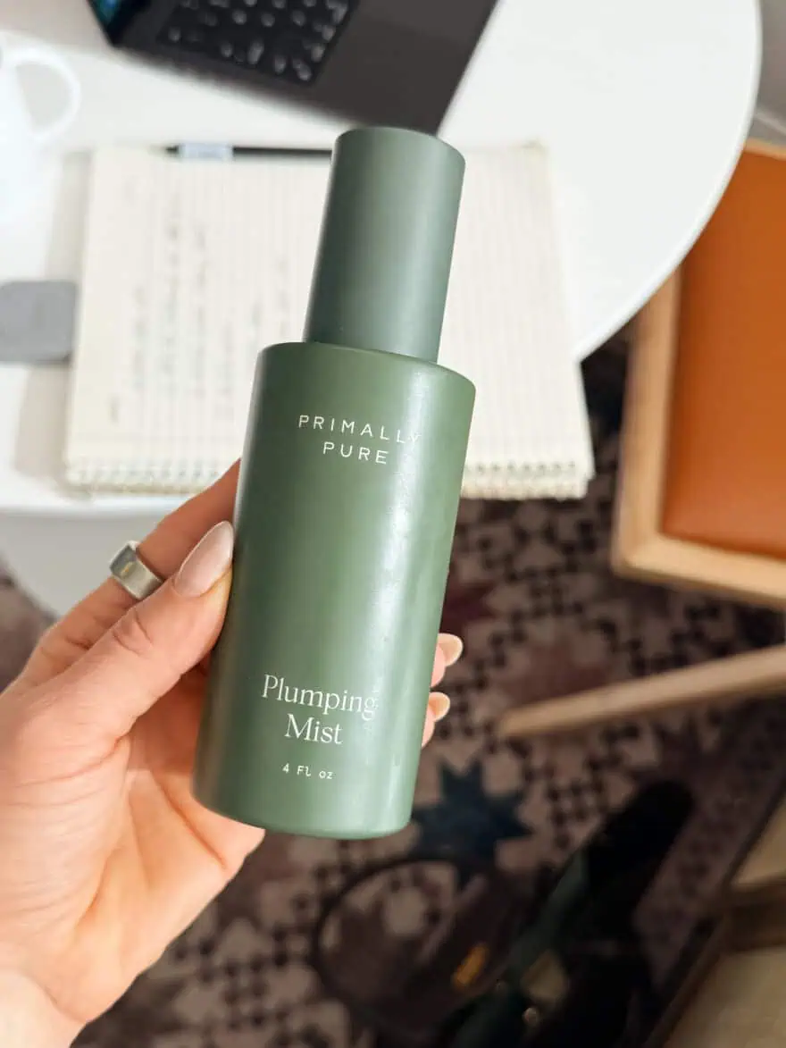Woman holding Primally Pure plumping mist bottle