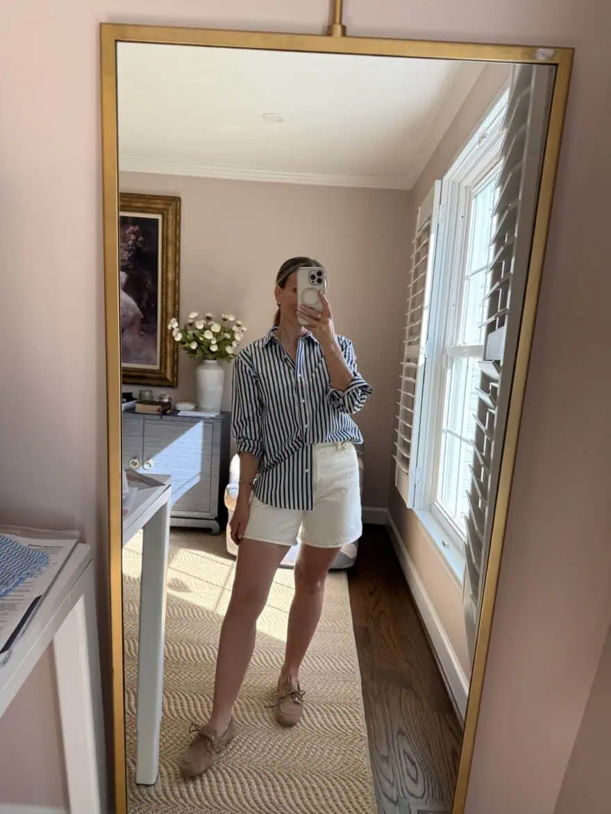 Woman wearing button-up top with white shorts and boat shoes