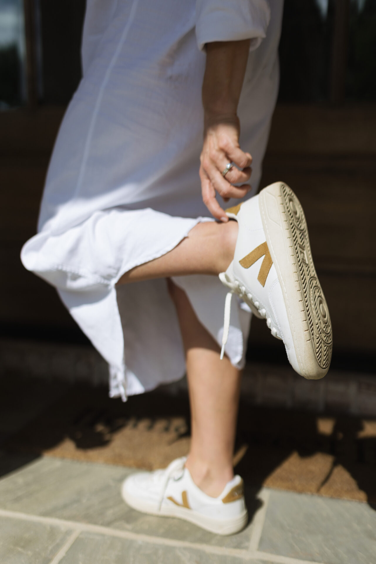 Close up of leather Vejas with a white dress.