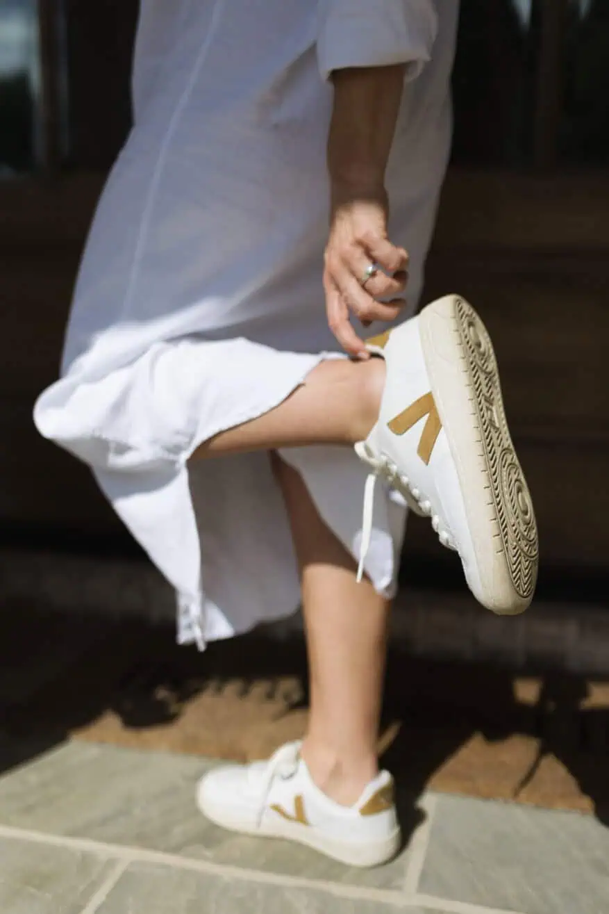 TeriLyn Adams wearing Vuori sneakers with linen dress
