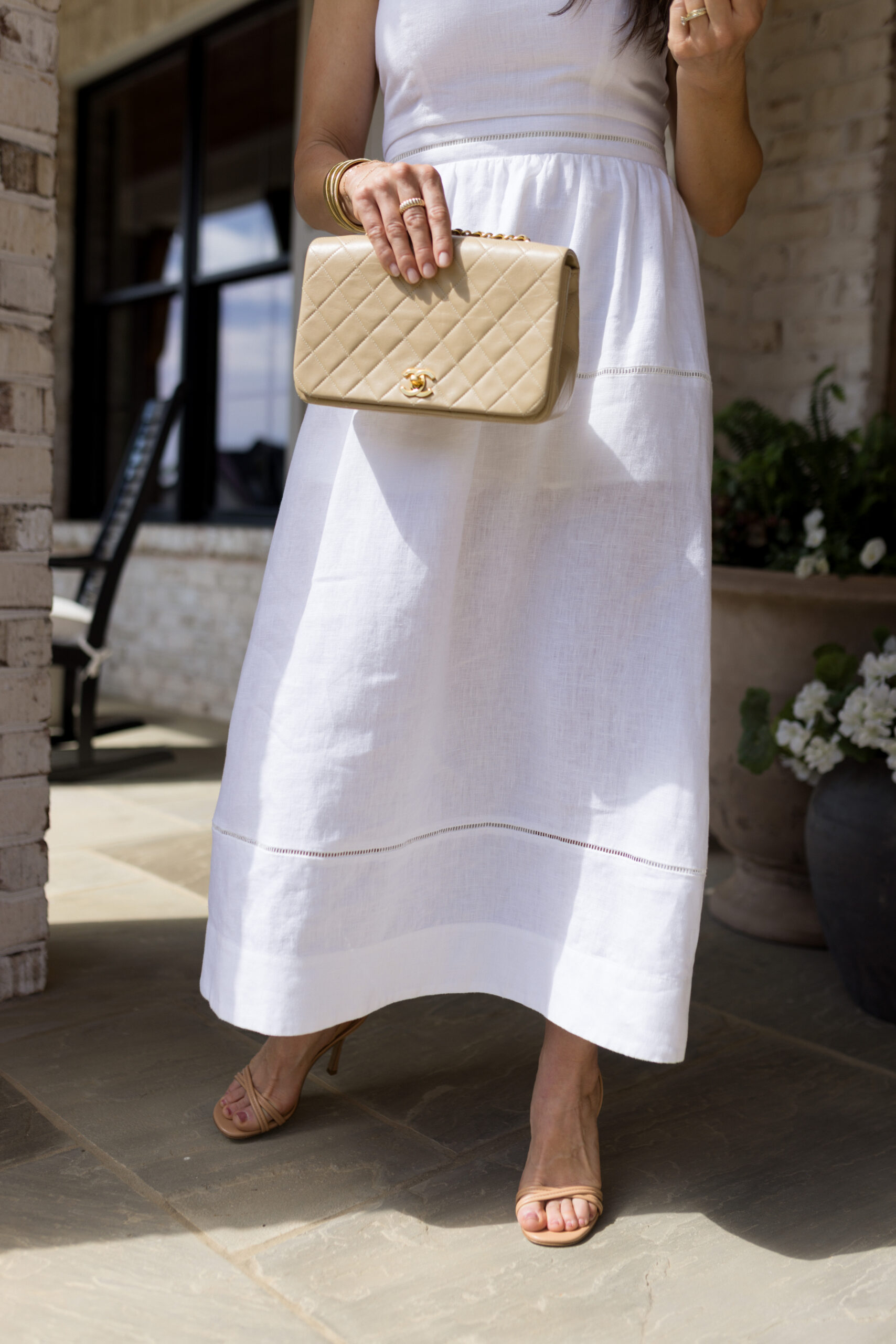 TeriLyn Adams standing wearing white dress and Tuckernuck sandals