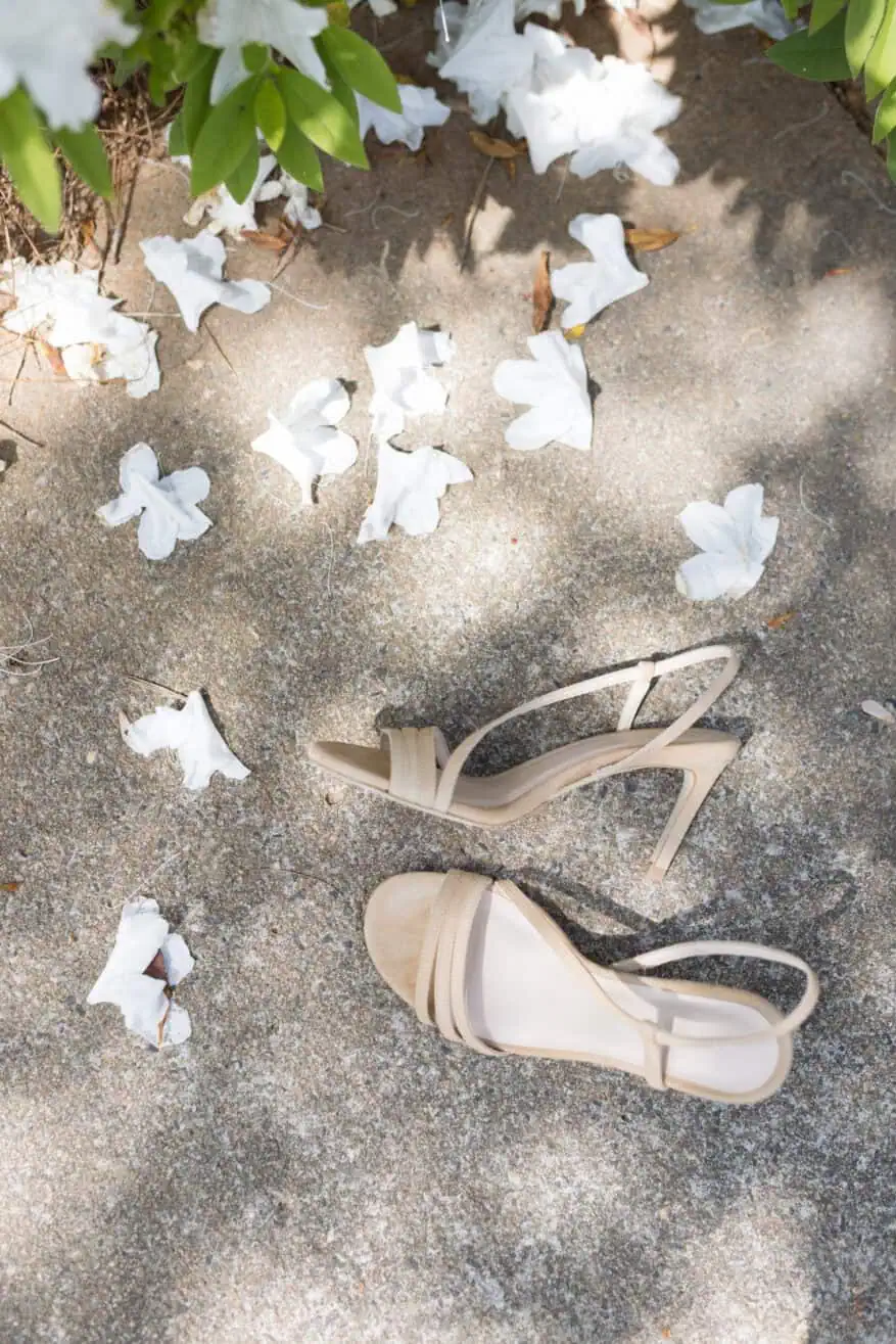 Tuckernuck heels on sidewalk with flowers