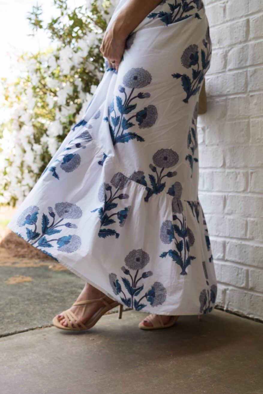 woman wearing flowy dress and strappy neutral heels