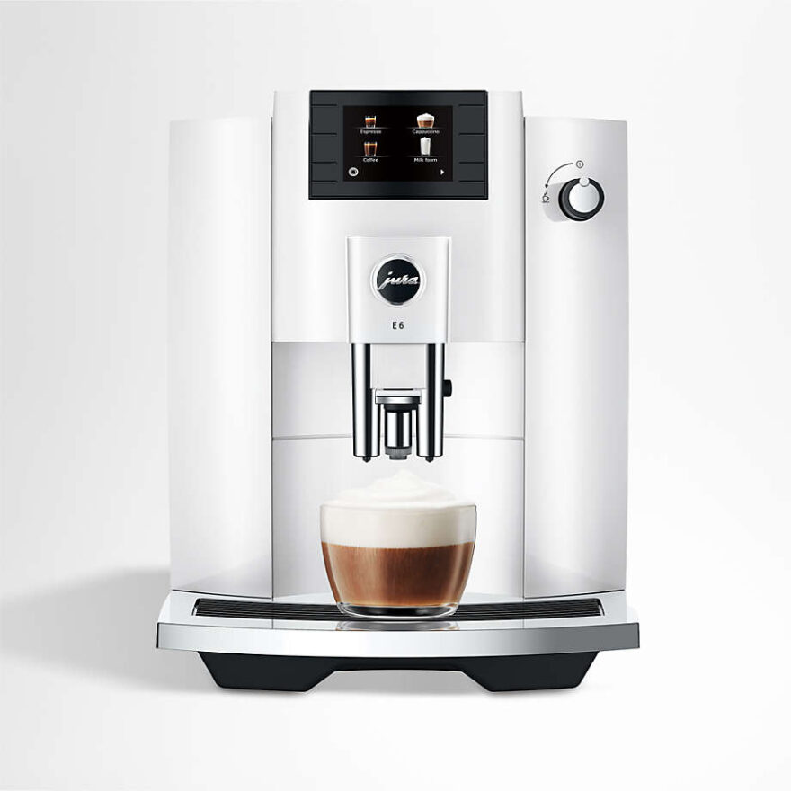 Jura E6 automatic espresso machine with a cappuccino in a glass mug