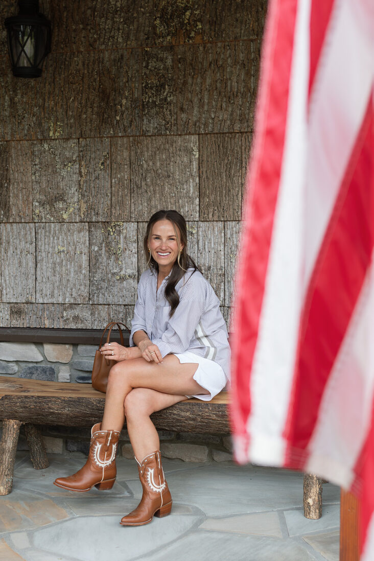 Terilyn adams wearing white jean shorts with button up top and cowboy boots