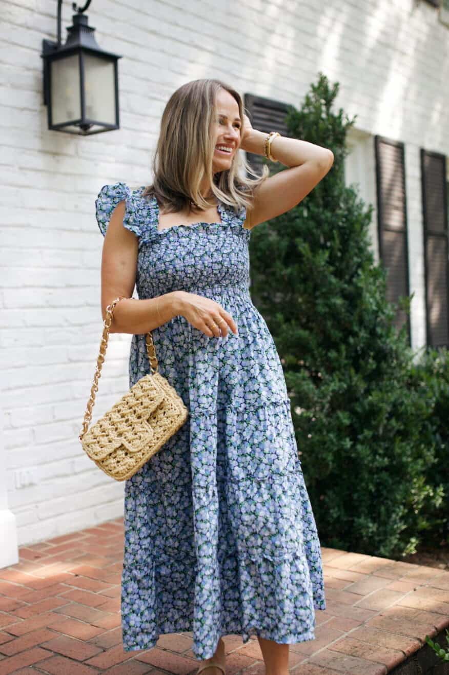 TeriLyn Adams wearing Hill House Ellie Nap dress and a straw bag