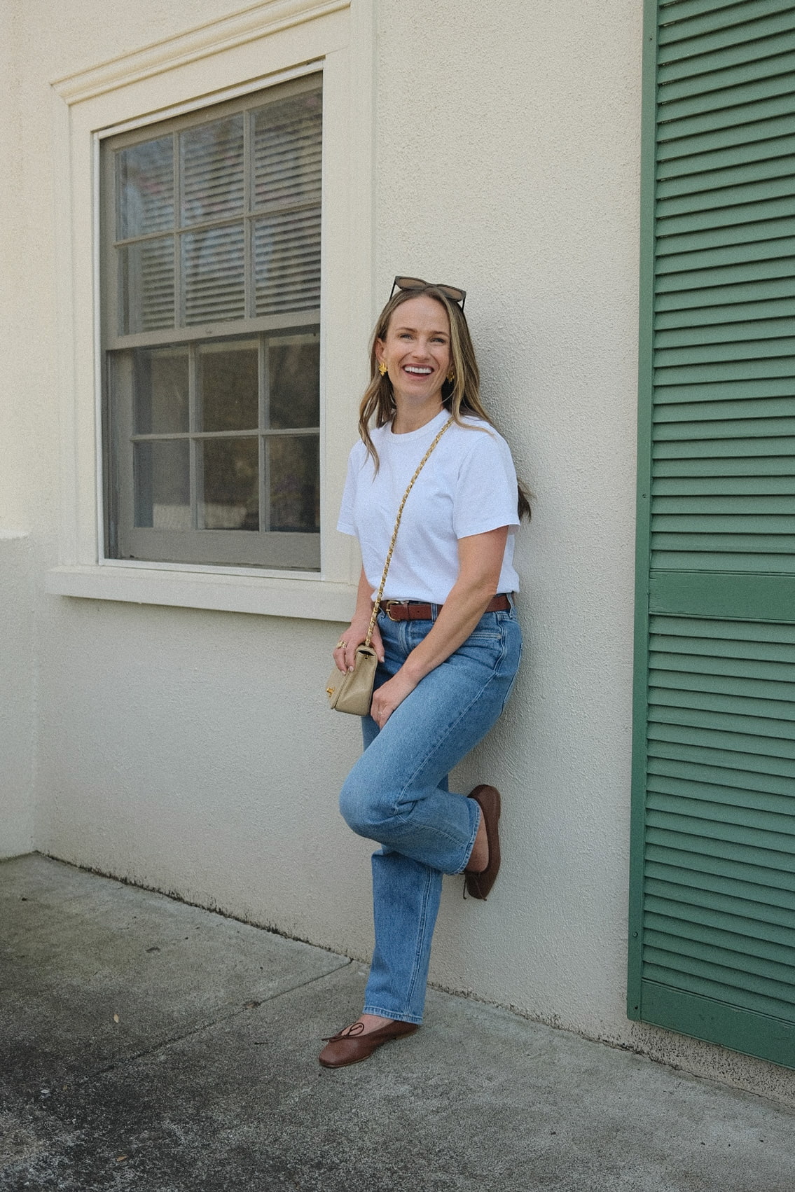 TeriLyn Adams infront of building with AYR straight leg jeans and ballet flats