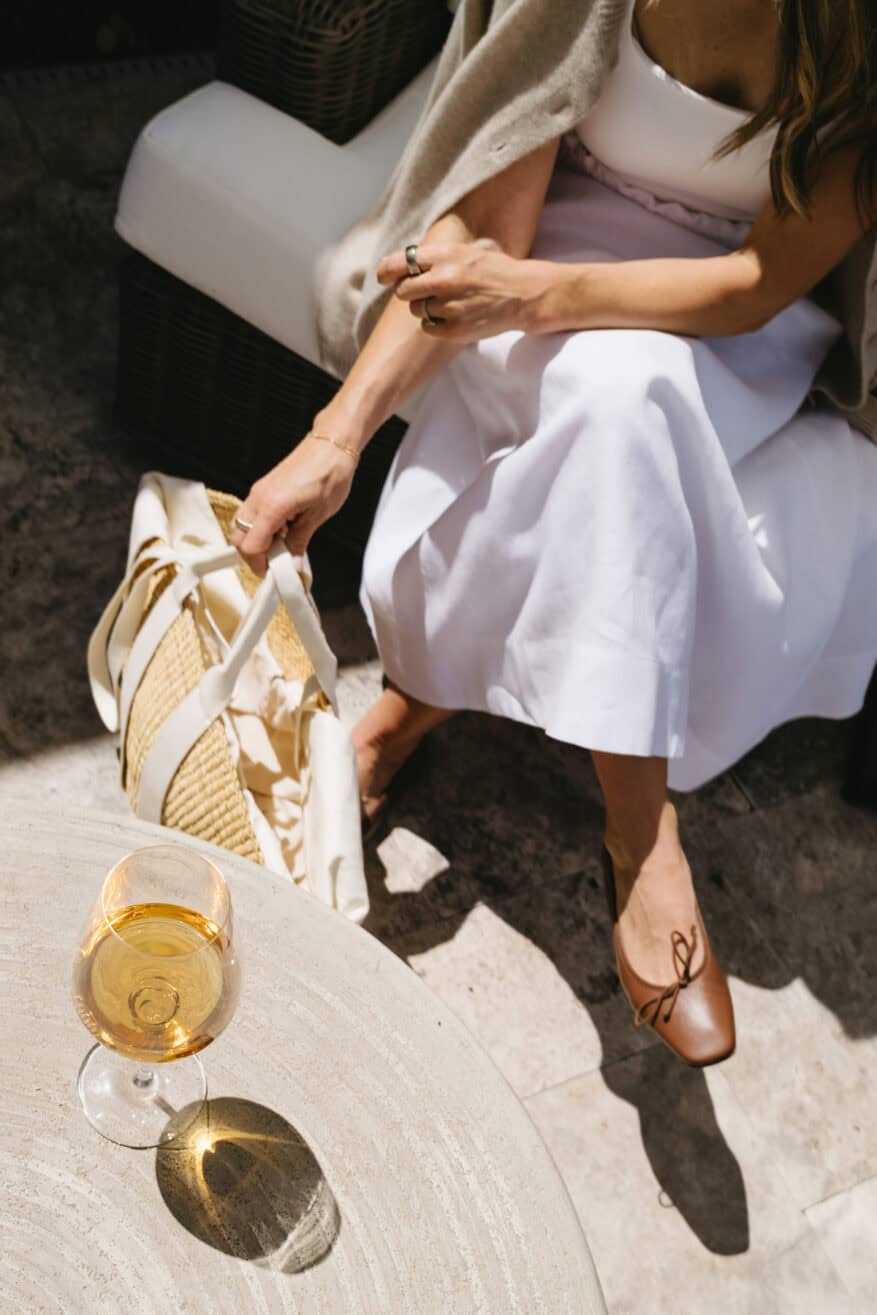 TeriLyn Adams maxi skirt outfit detail with cognac ballet flats and a straw bag with white ribbon handles