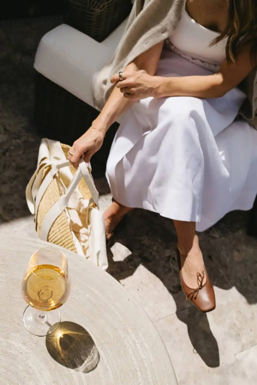 TeriLyn Adams maxi skirt outfit detail with cognac ballet flats and a straw bag with white ribbon handles